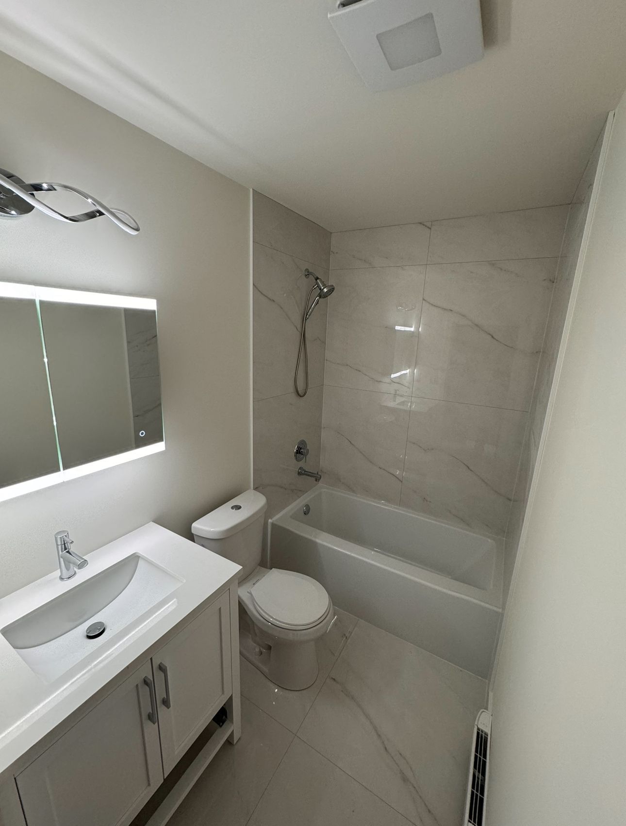 A hose is being installed in a yard next to a house.