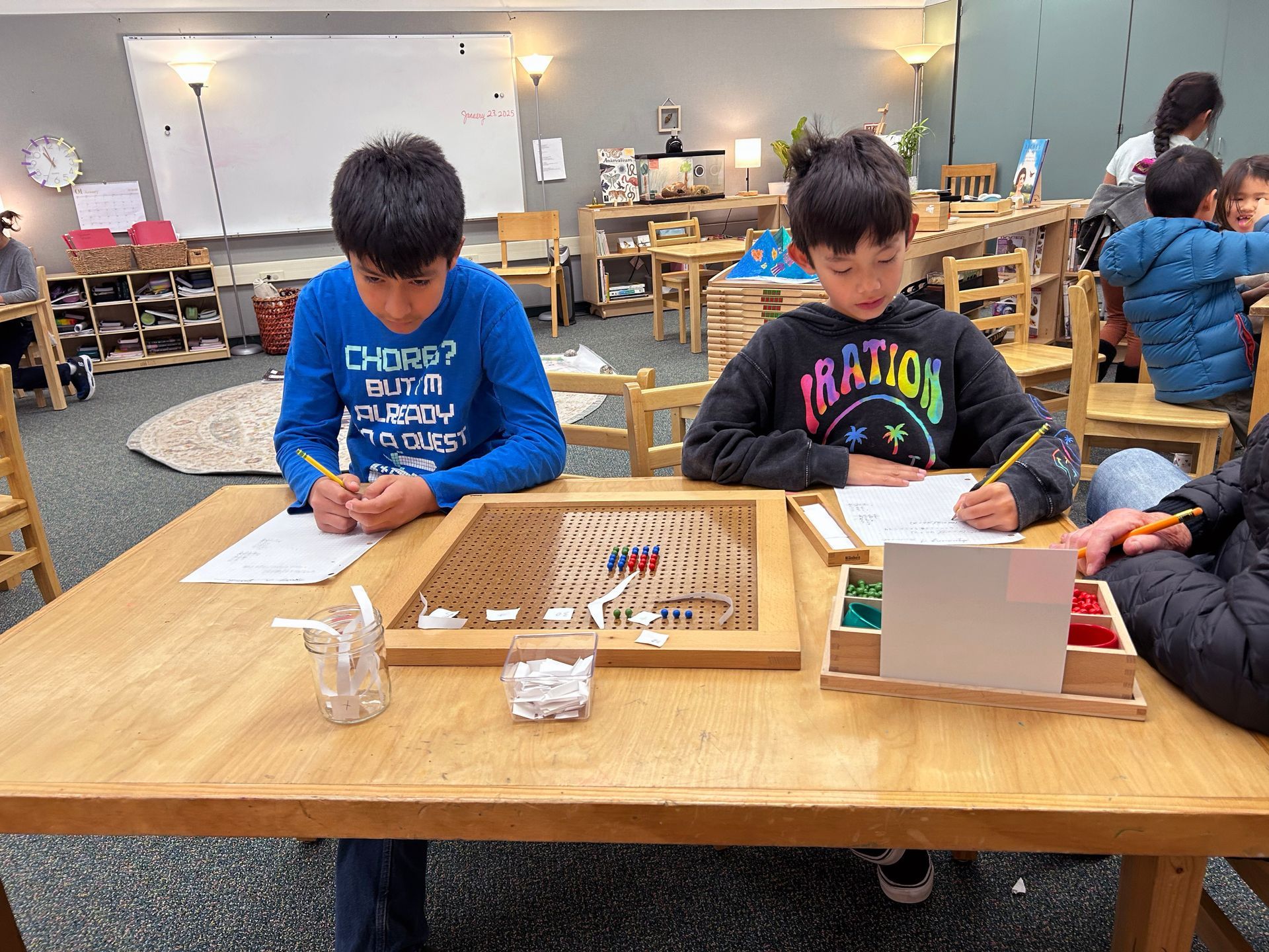 Children working with the Montessori algebraic peg board. 