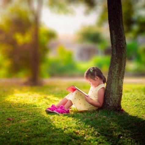 montessori child reading a book
