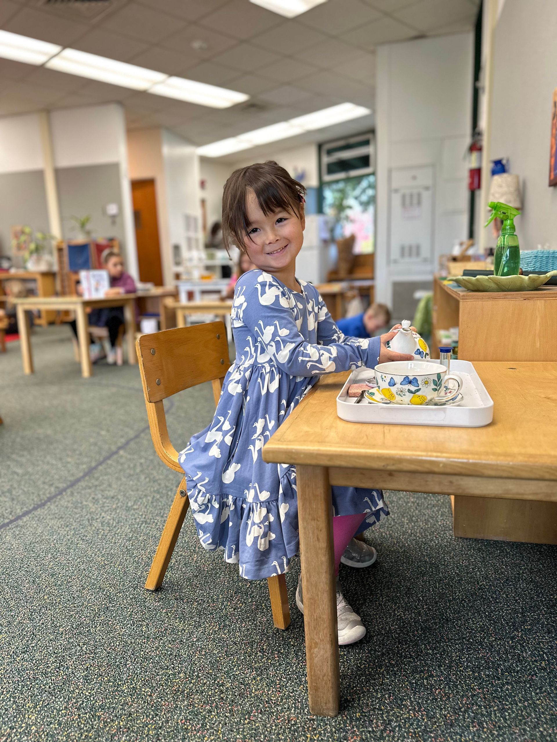 montessori child with practical life materials