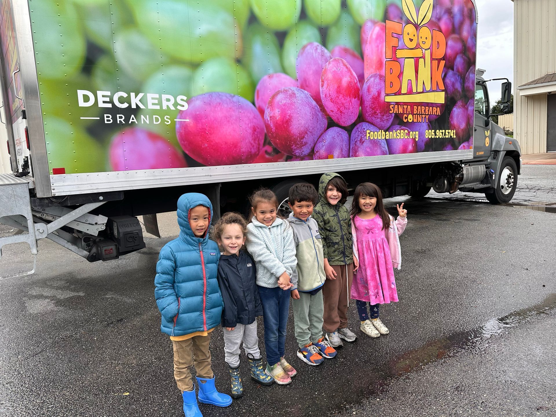 montessori children outside beside a truck