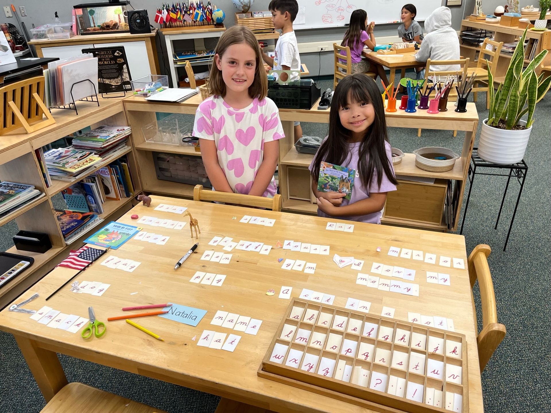 Montessori children working with language materials.