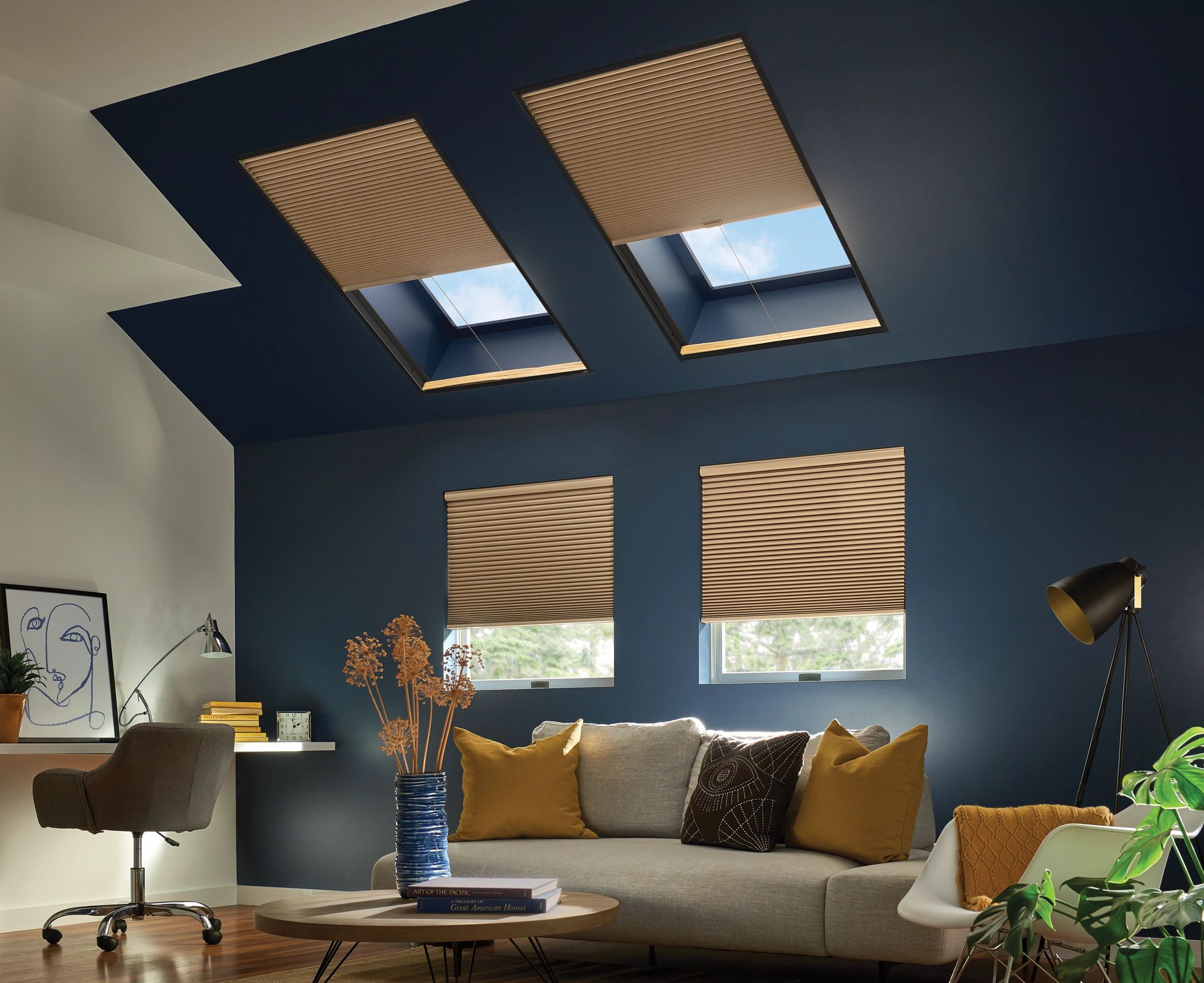 Living room with blue walls, skylights, and patterned window shades.