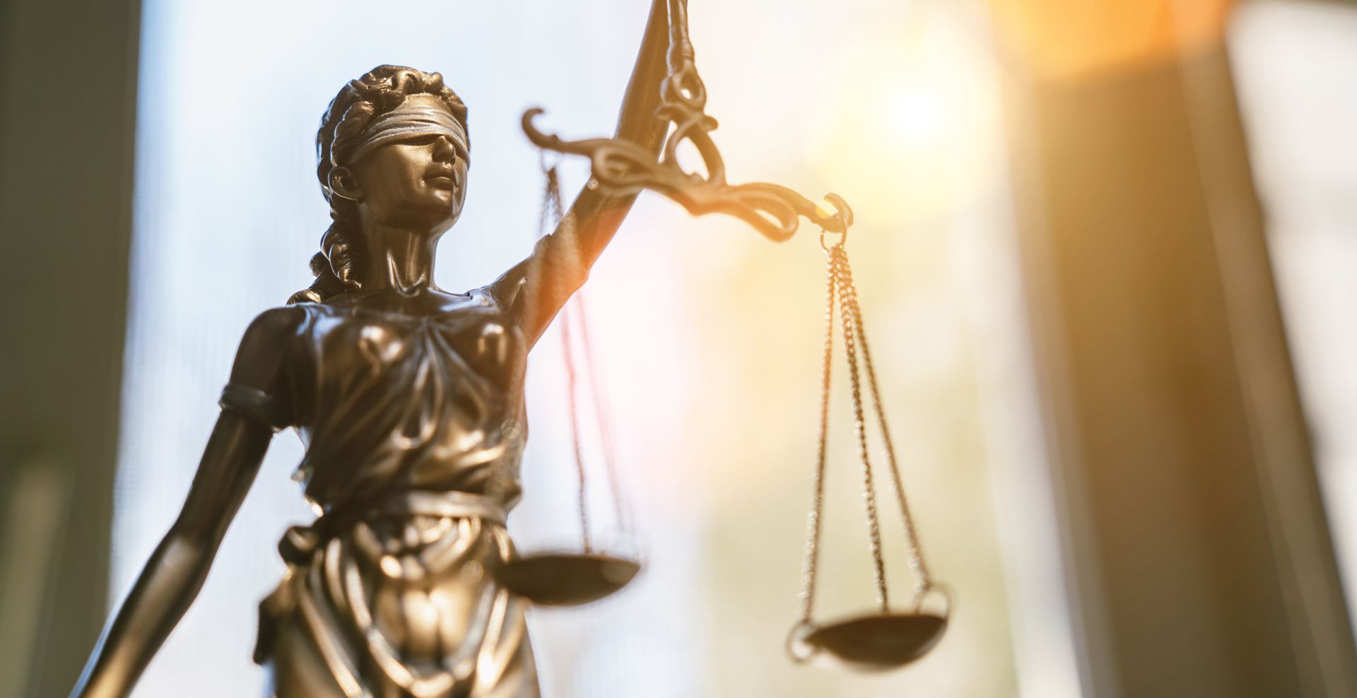 A close up of a statue of justice holding scales of justice.