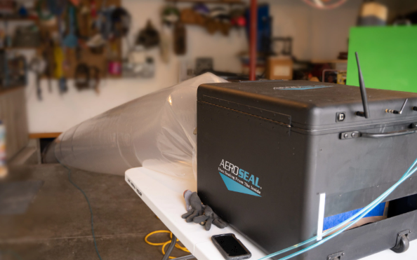 Black box with a transparent plastic bag on a table in a workshop or garage
