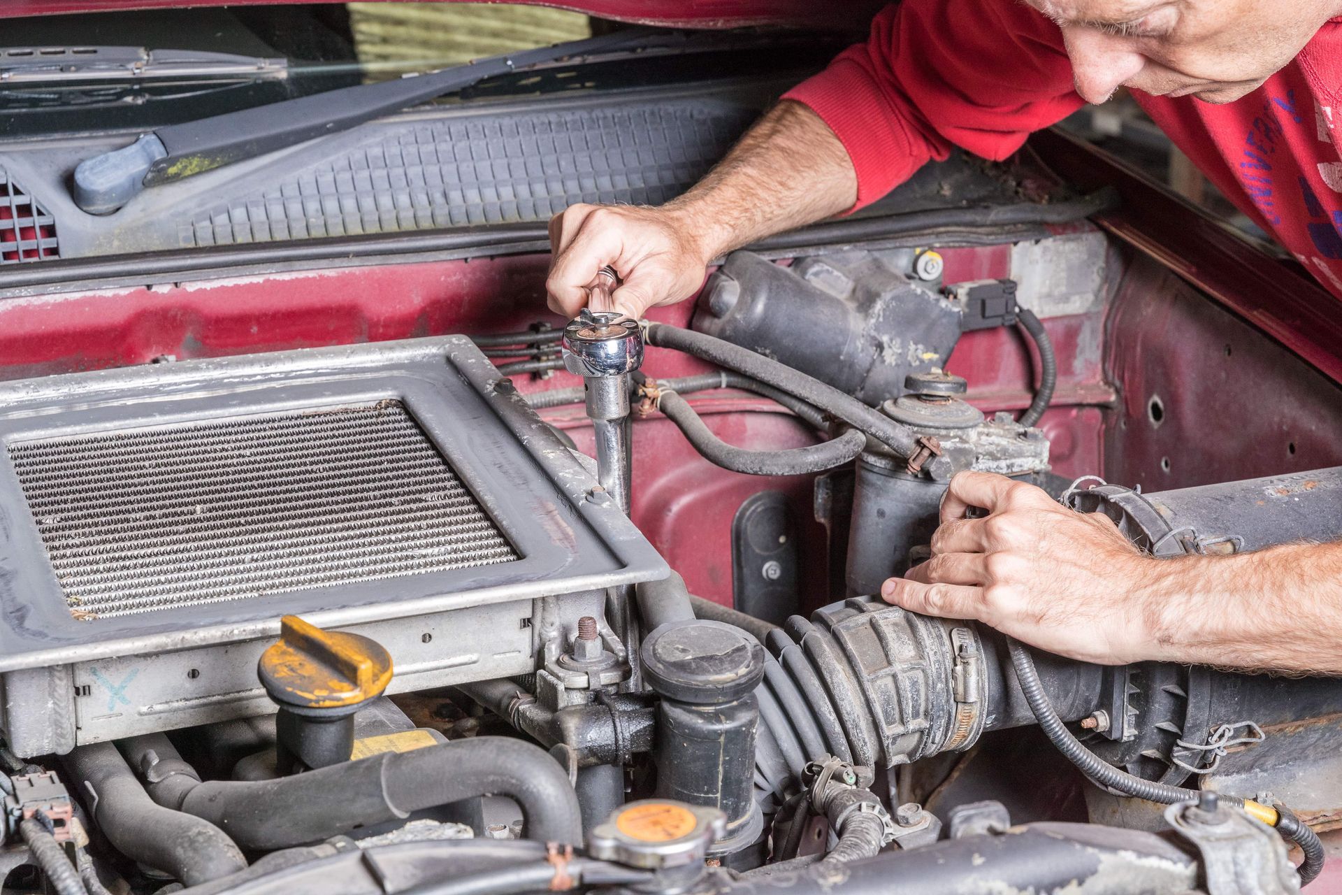 man checking car intercooler