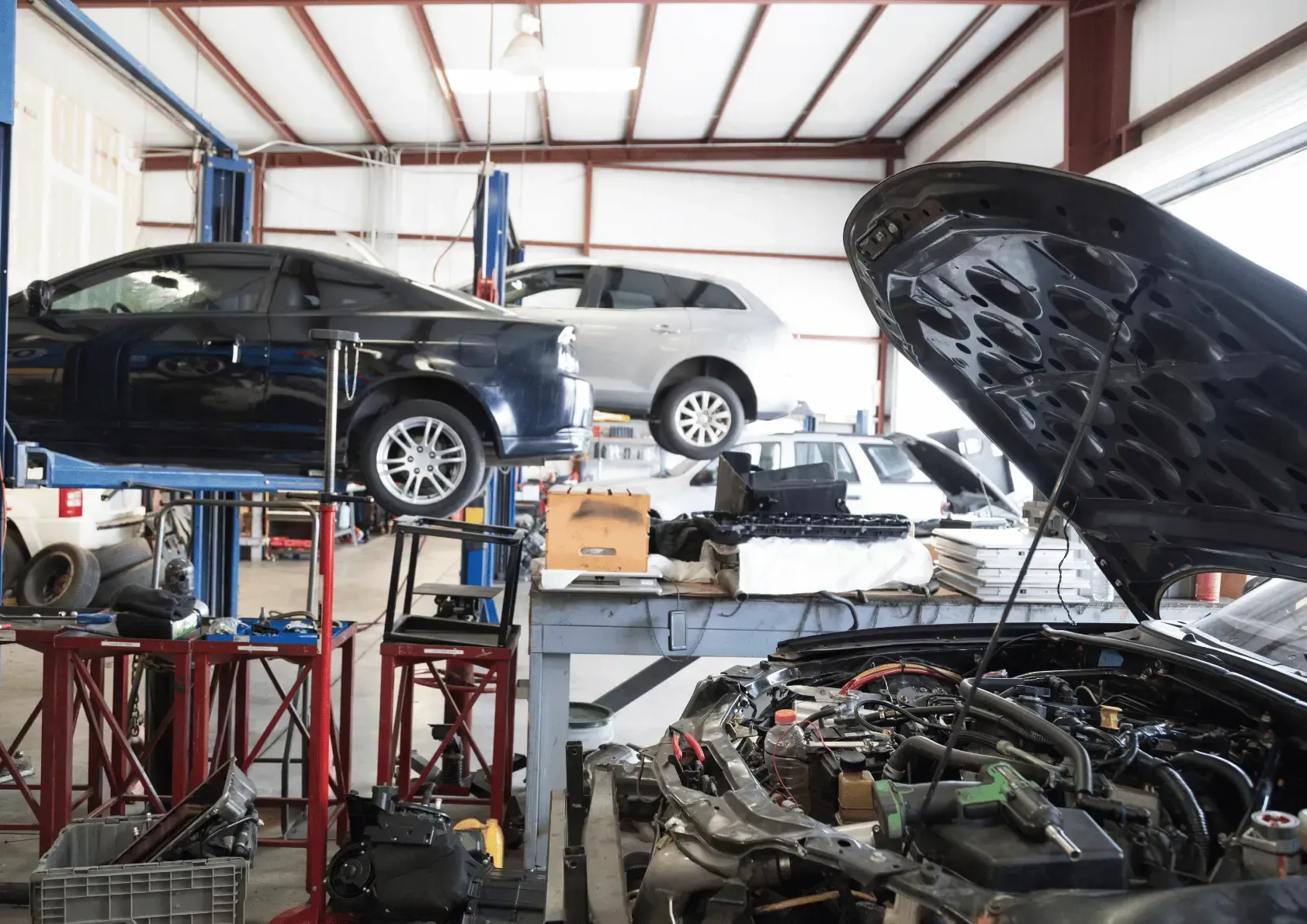 A car with a flat tire is parked on the side of the road.