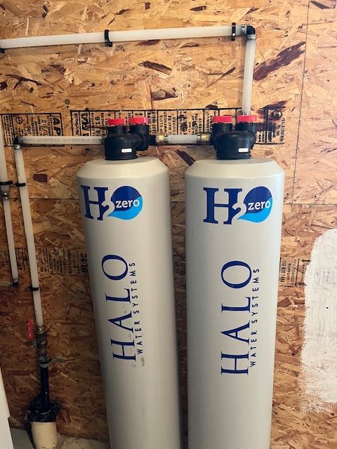 Two white cylinders with halo water systems written on them