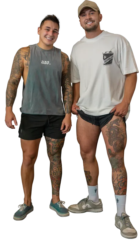 A very muscular man is standing with his hands on his hips.
