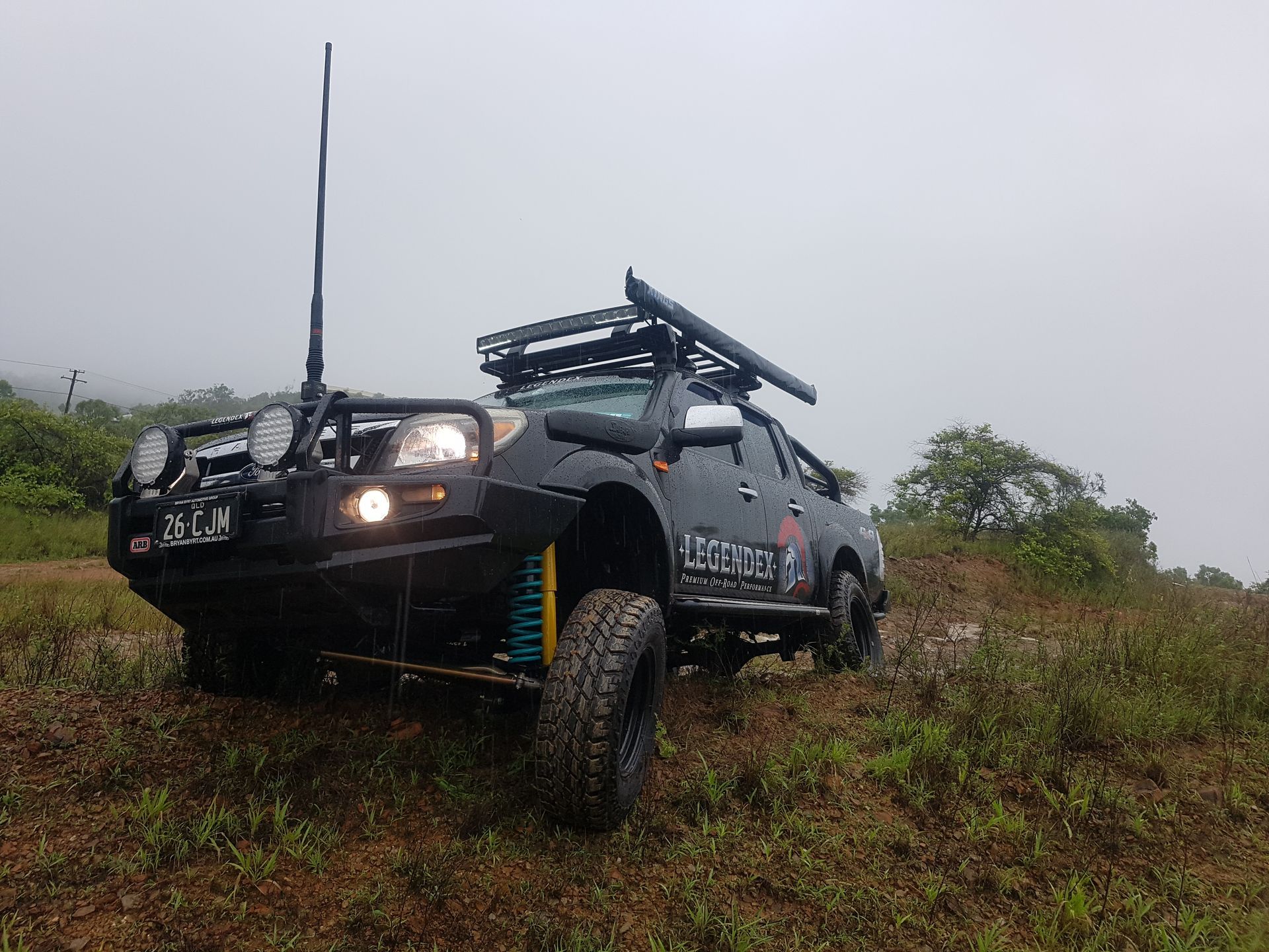 A Blue Off-Road Truck Drives Over a Dry &mdash; Ironhide Customs In Garbutt, QLD