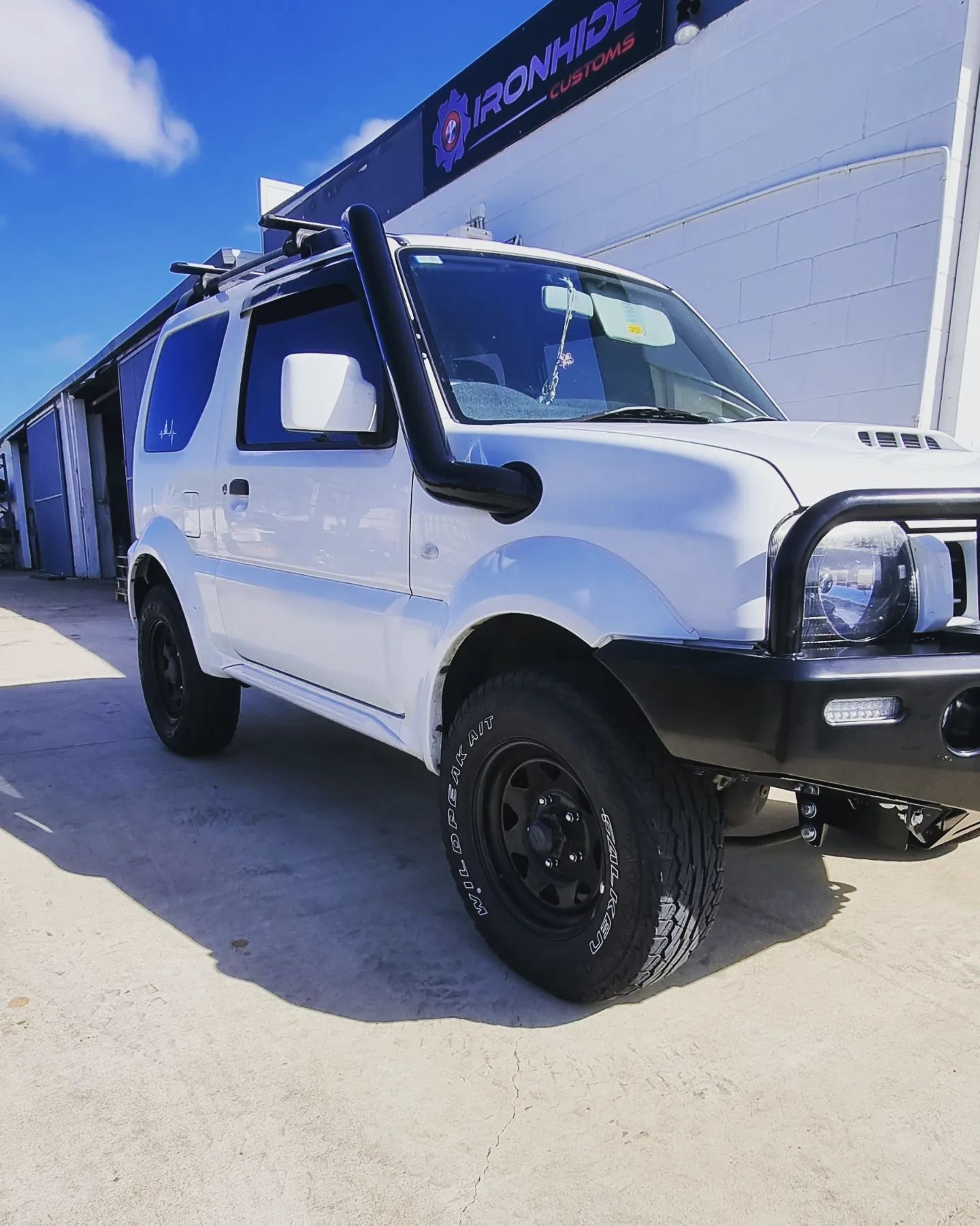 White Off-road SUV Parked Beside a Building — Ironhide Customs In Garbutt, QLD
