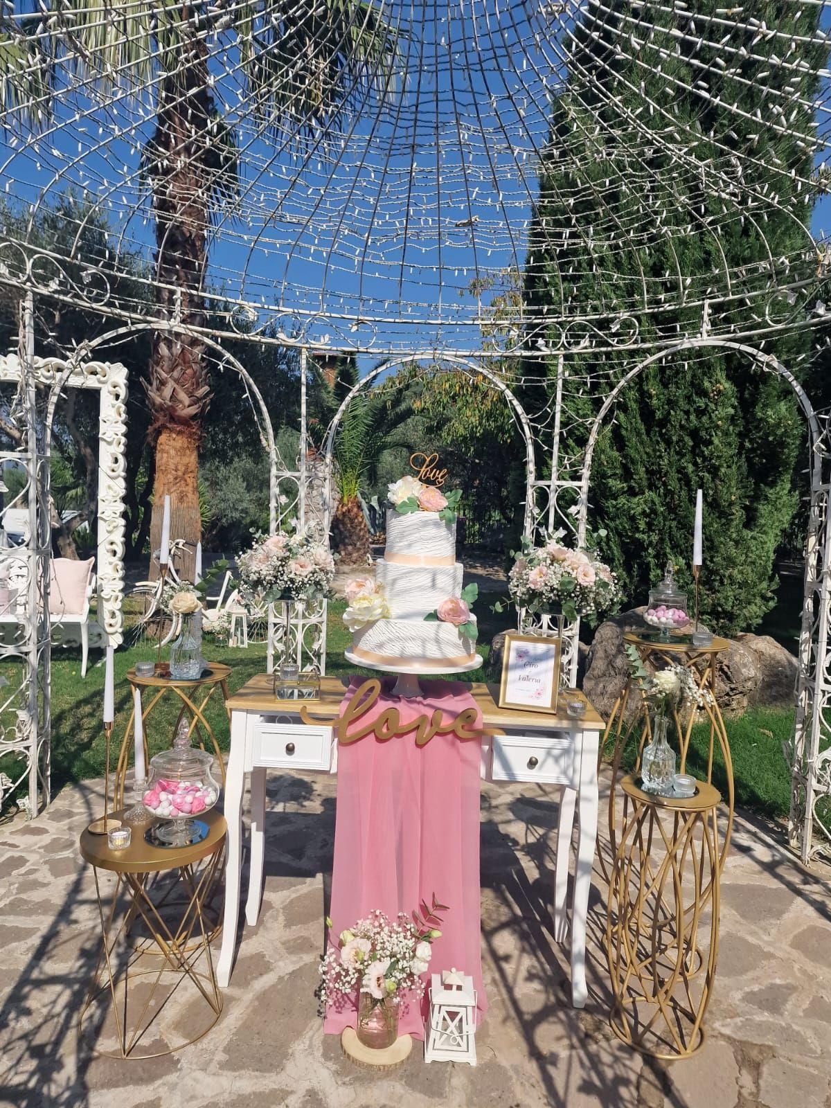 tavolo con una torta sopra davanti a un gazebo