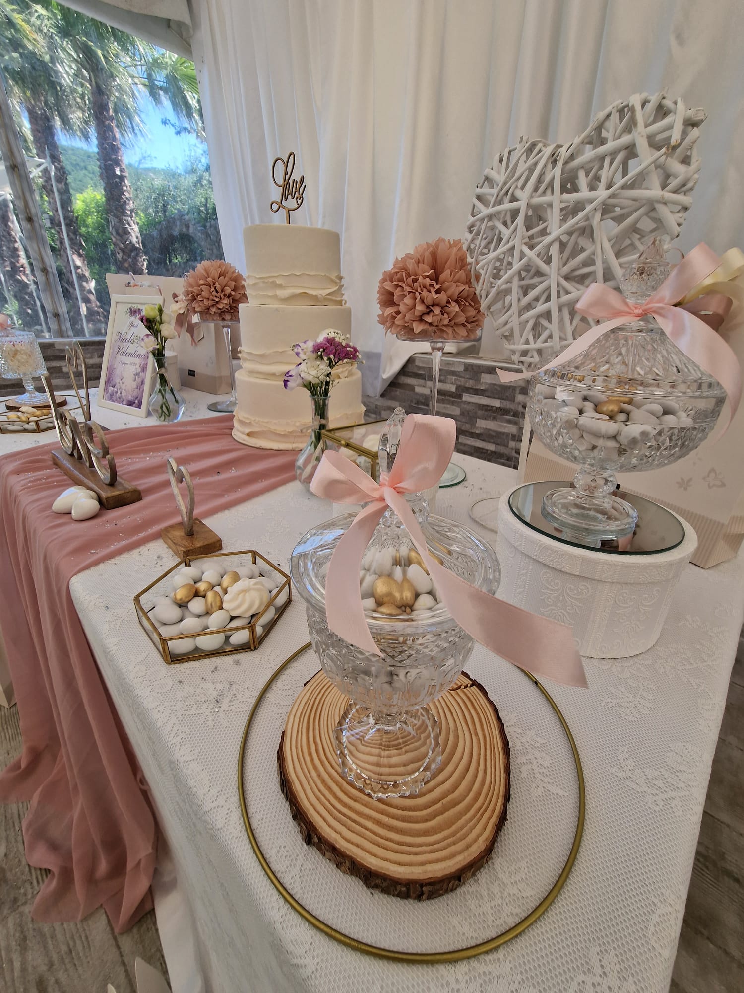 tavolo nuziale con una torta, dolciumi e fiori sopra