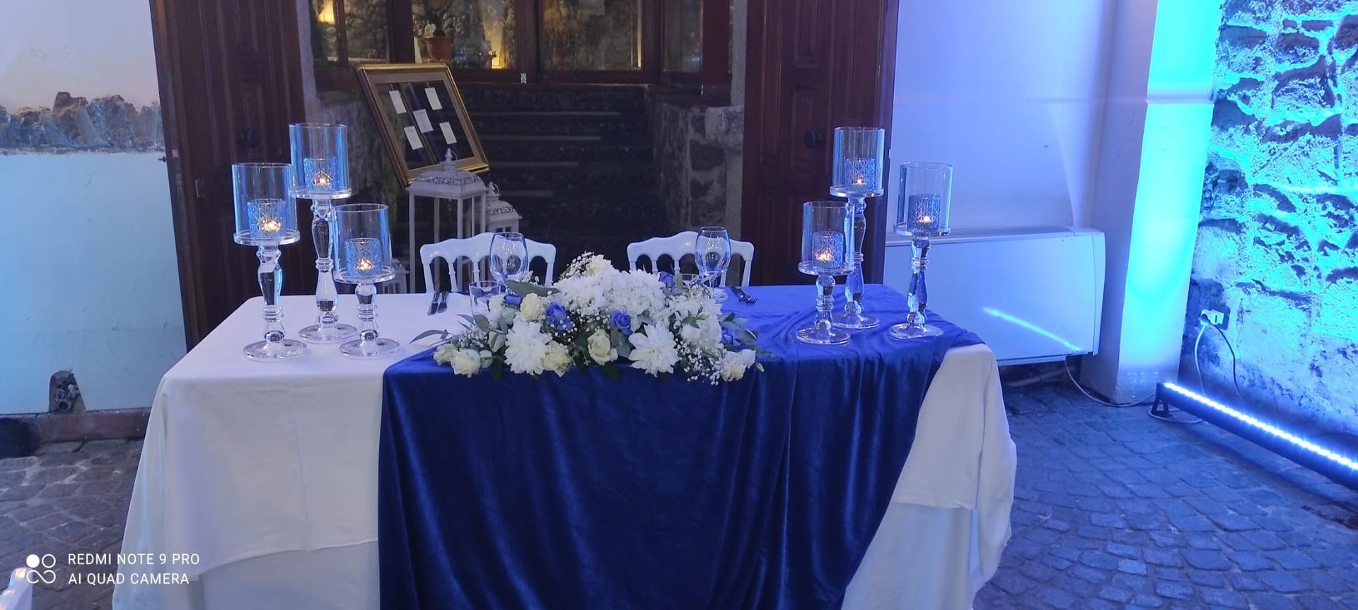 tavolo con una tovaglia blu e delle candele