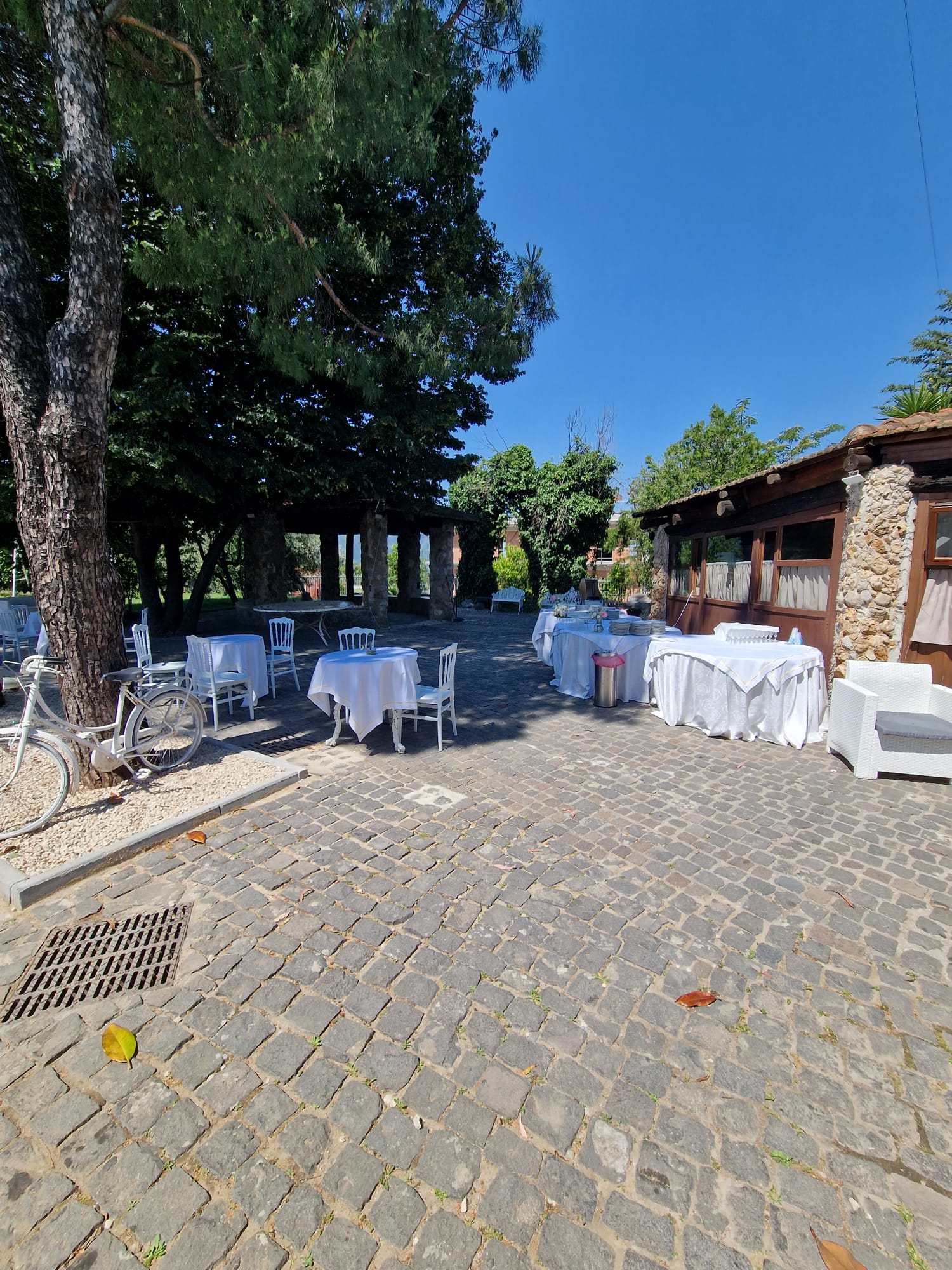 vialetto in mattoni con tavoli e sedie sistemati di fronte a un edificio