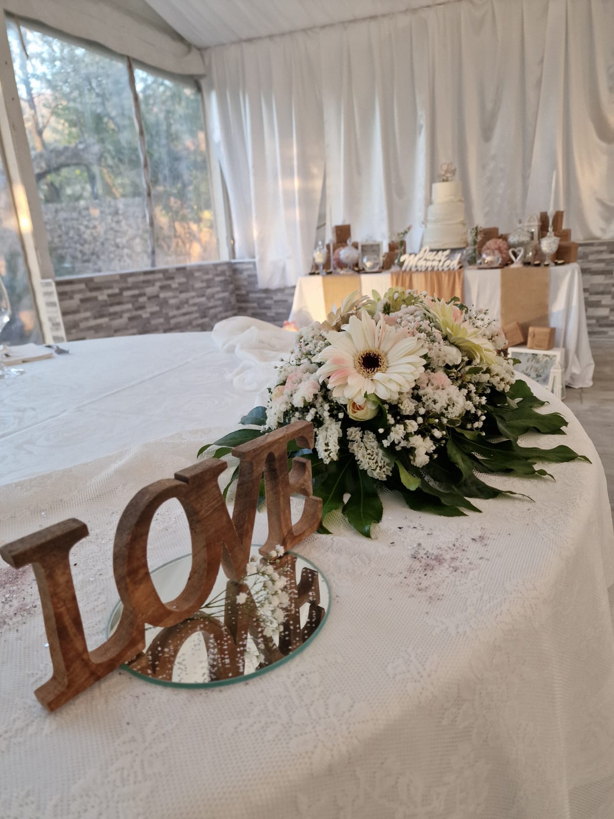 tavolo con fiori e una scritta decorativa