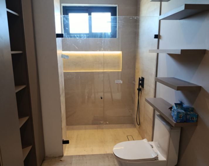 Interior de almacén con carretillas elevadoras, estanterías repletas de mercancías e iluminación industrial.