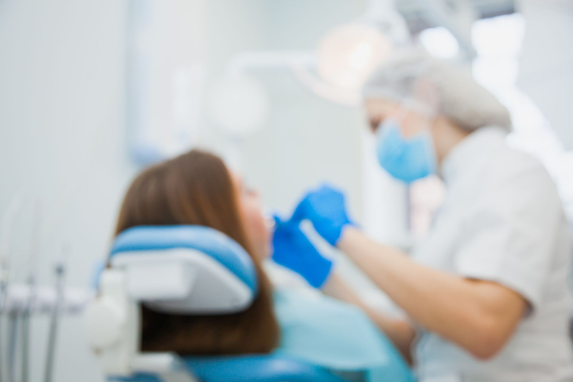 Emergency dentistry treatment with dentist and patient at dental clinic office blurred image.