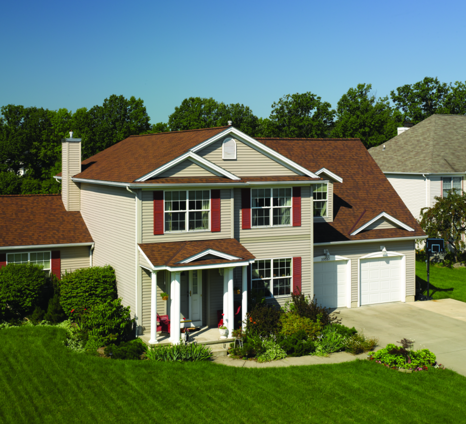 A large house with a brown roof and white trim