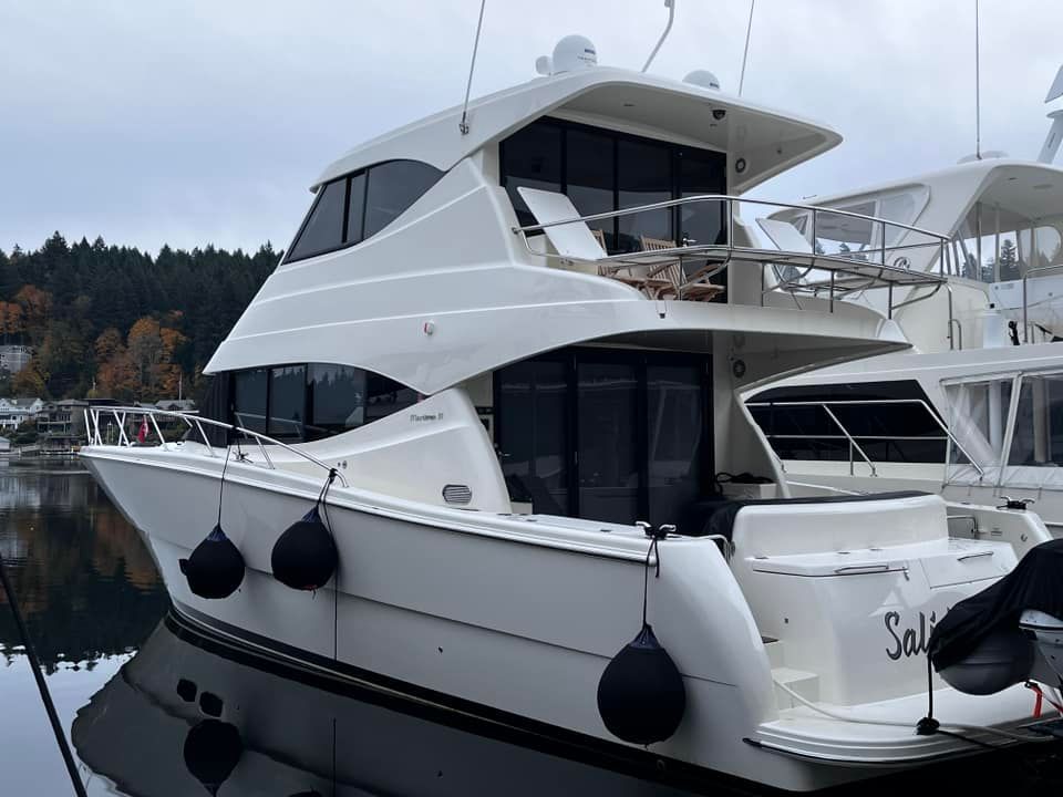 A large white yacht is floating on top of a large body of water.