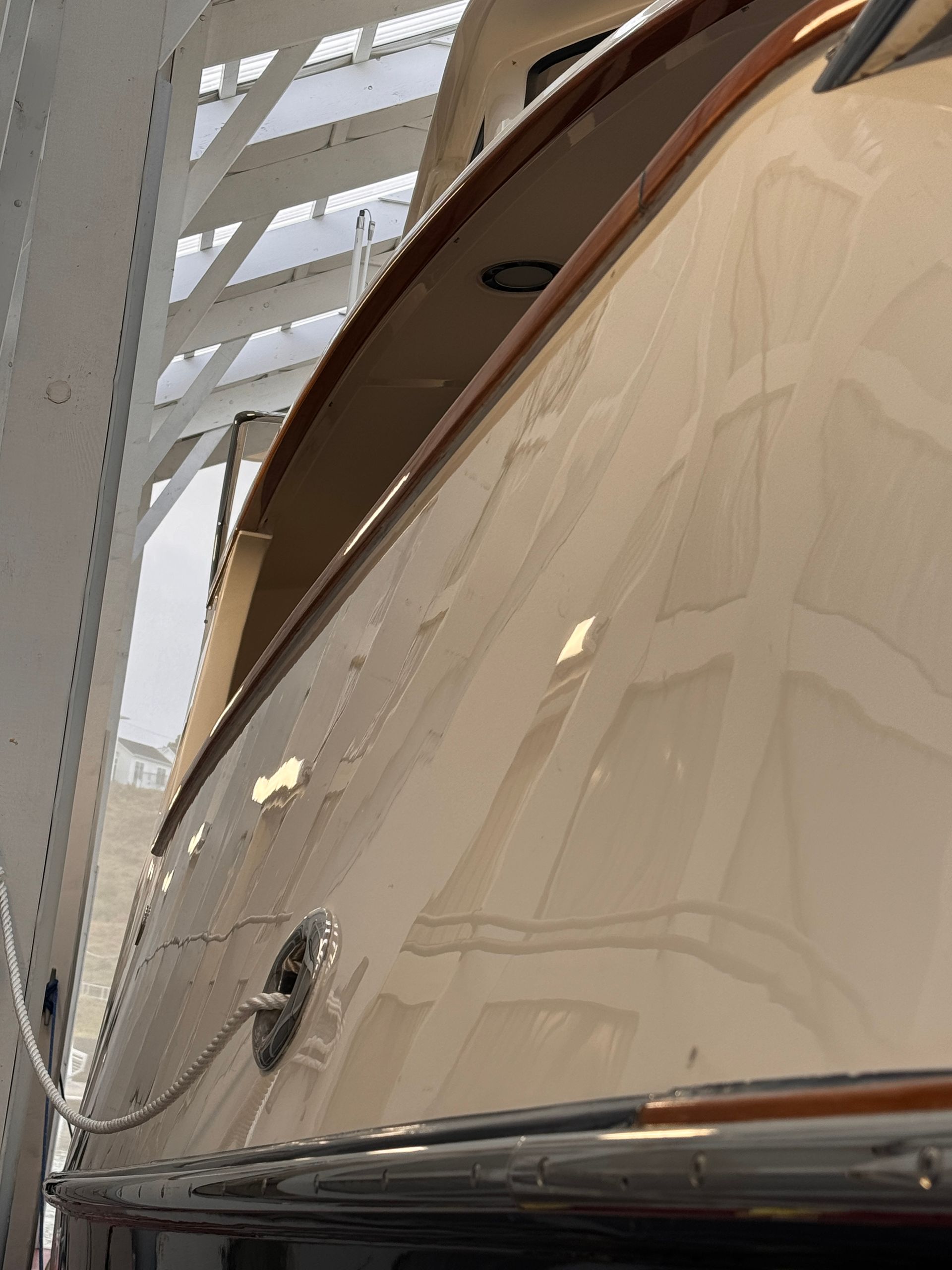 A close up of a white boat with a wooden trim