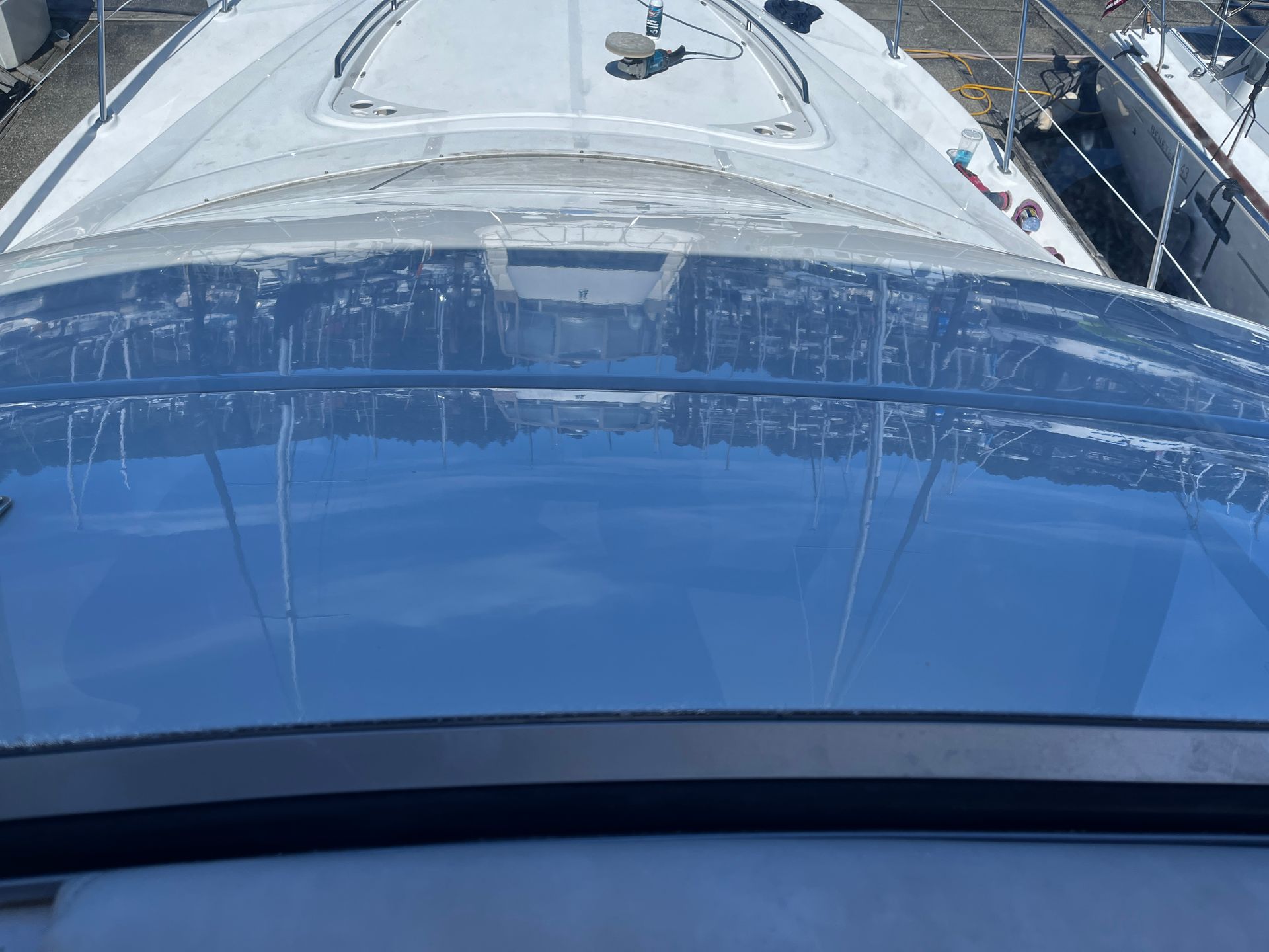 A boat with a clear roof is docked in a marina.