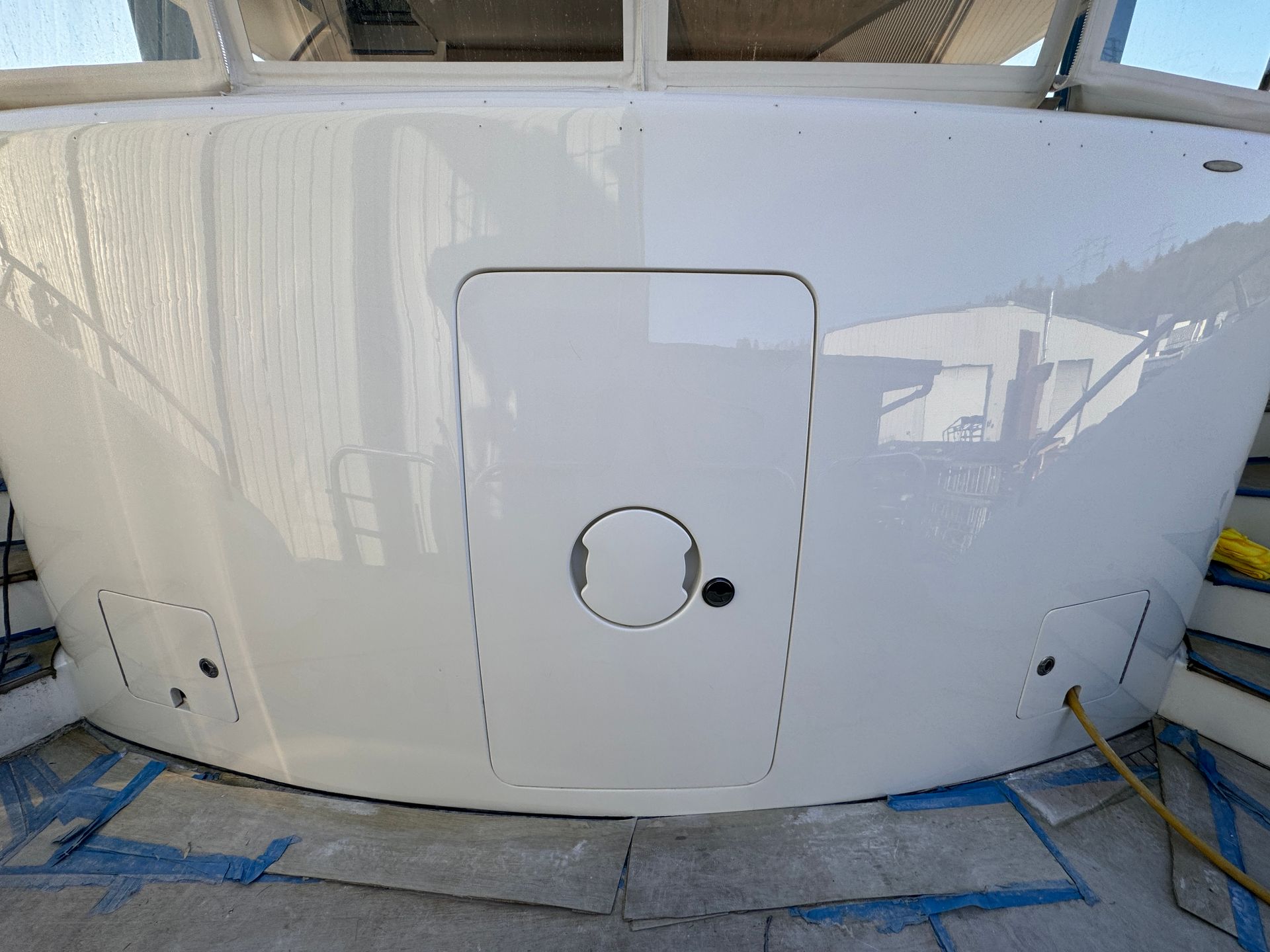 The back of a white boat with a door and a window.