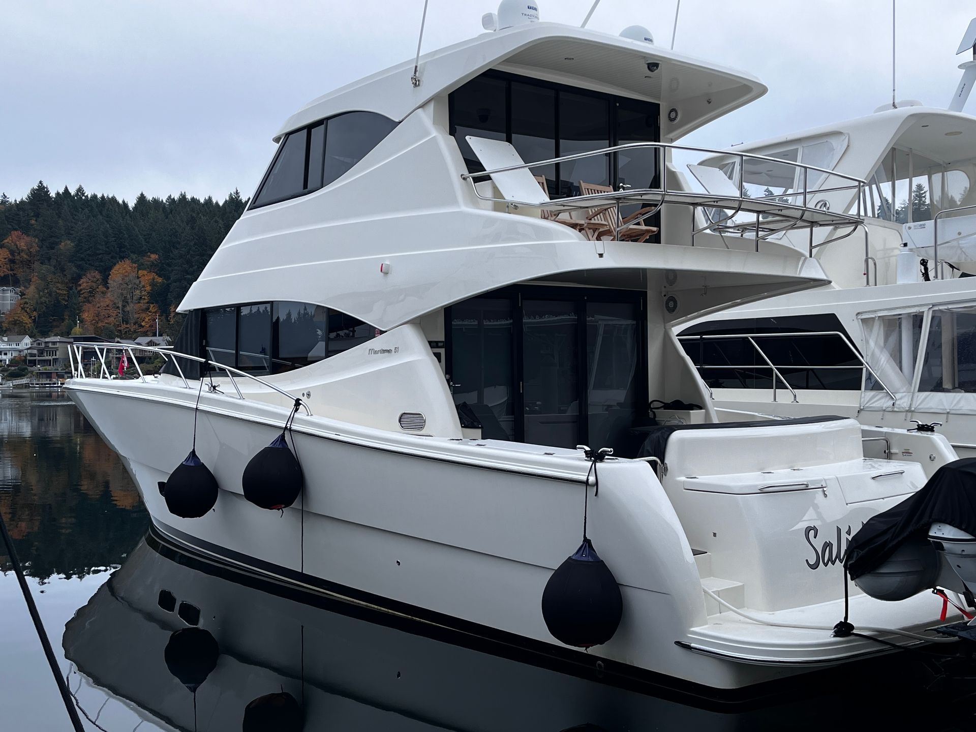 A white boat with the name sally on the back