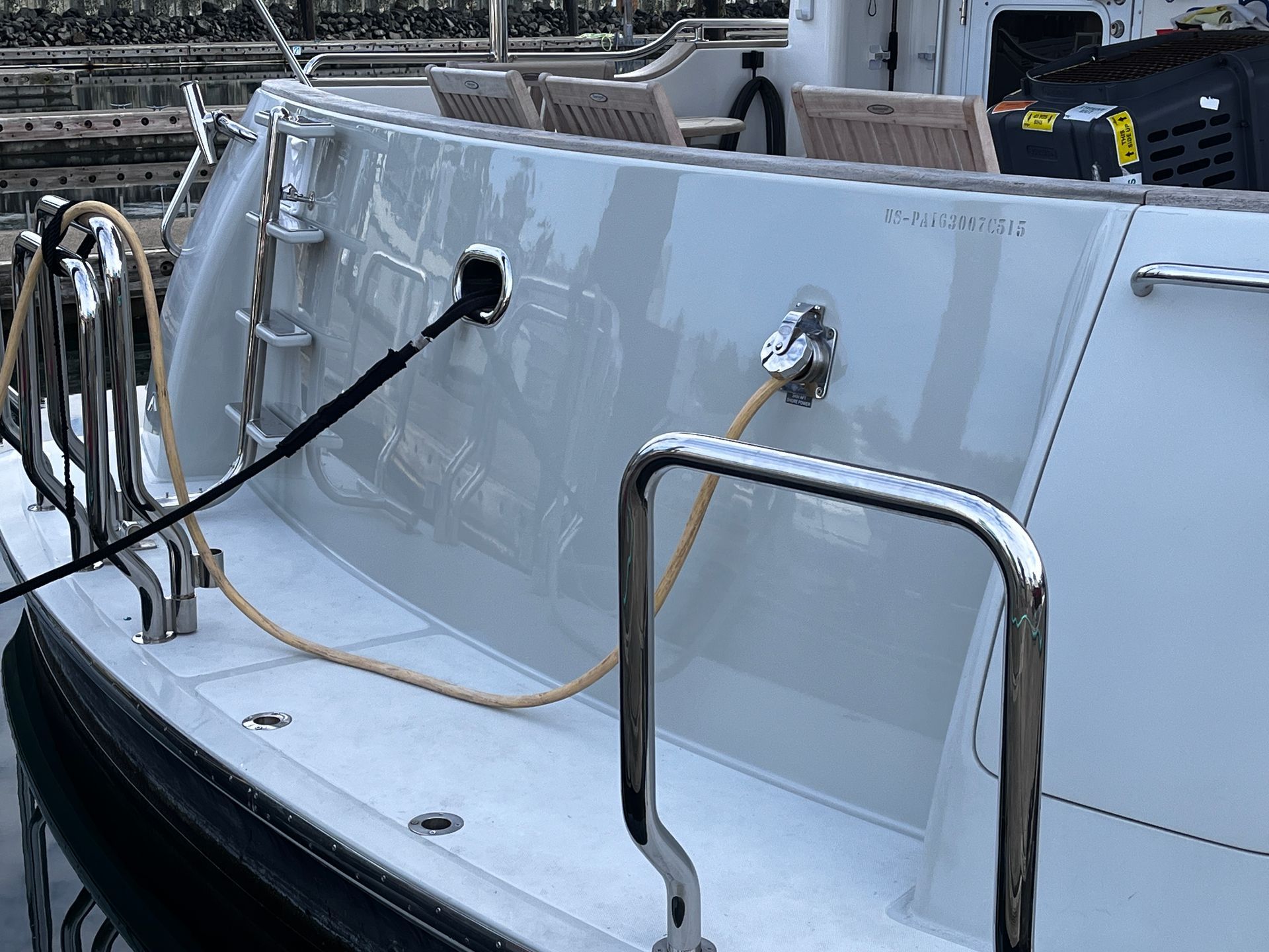 The back of a boat with a hose attached to it.