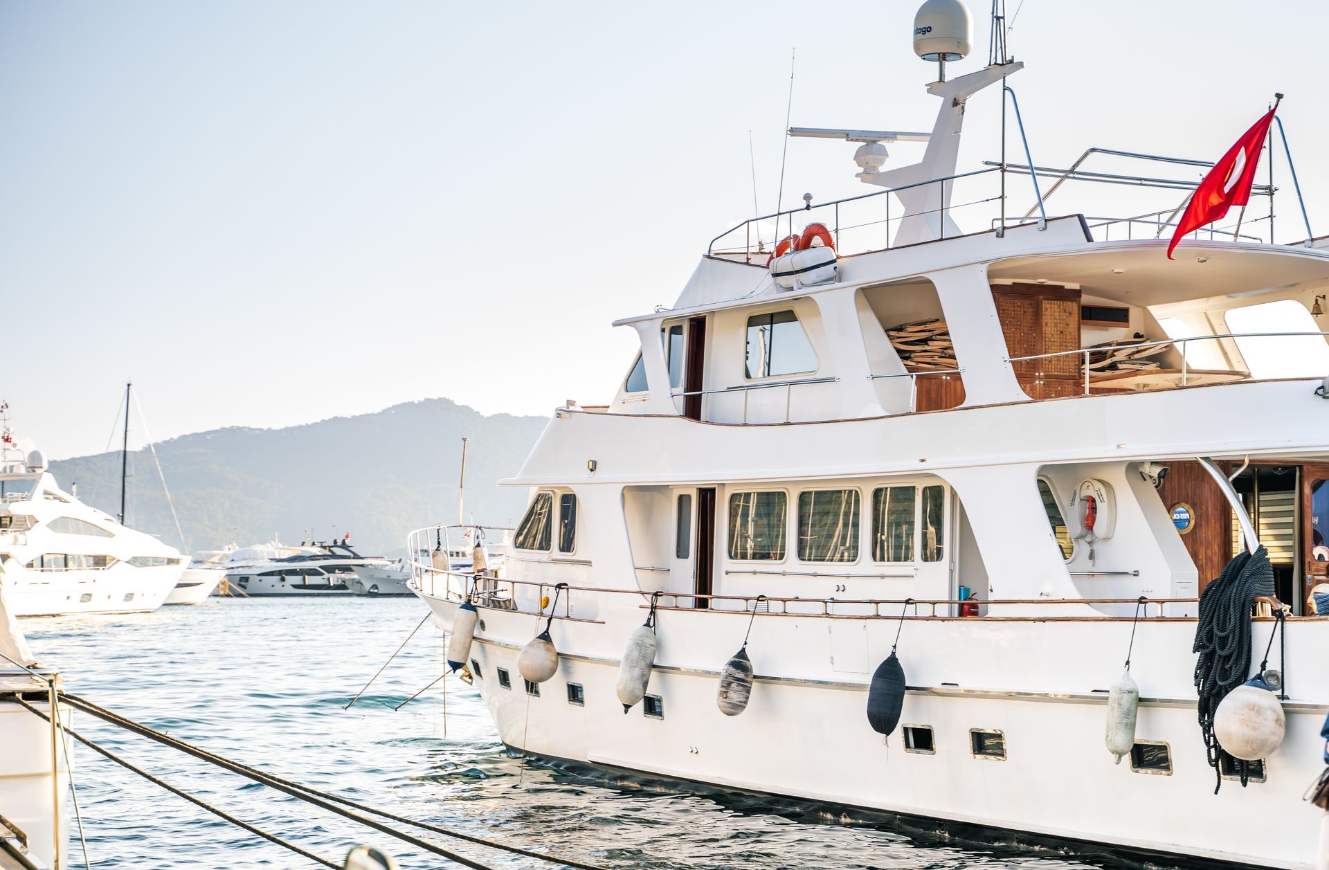 A large white yacht is docked in the water.