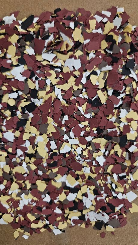 Flakes of red, yellow, black, white and brown chips.