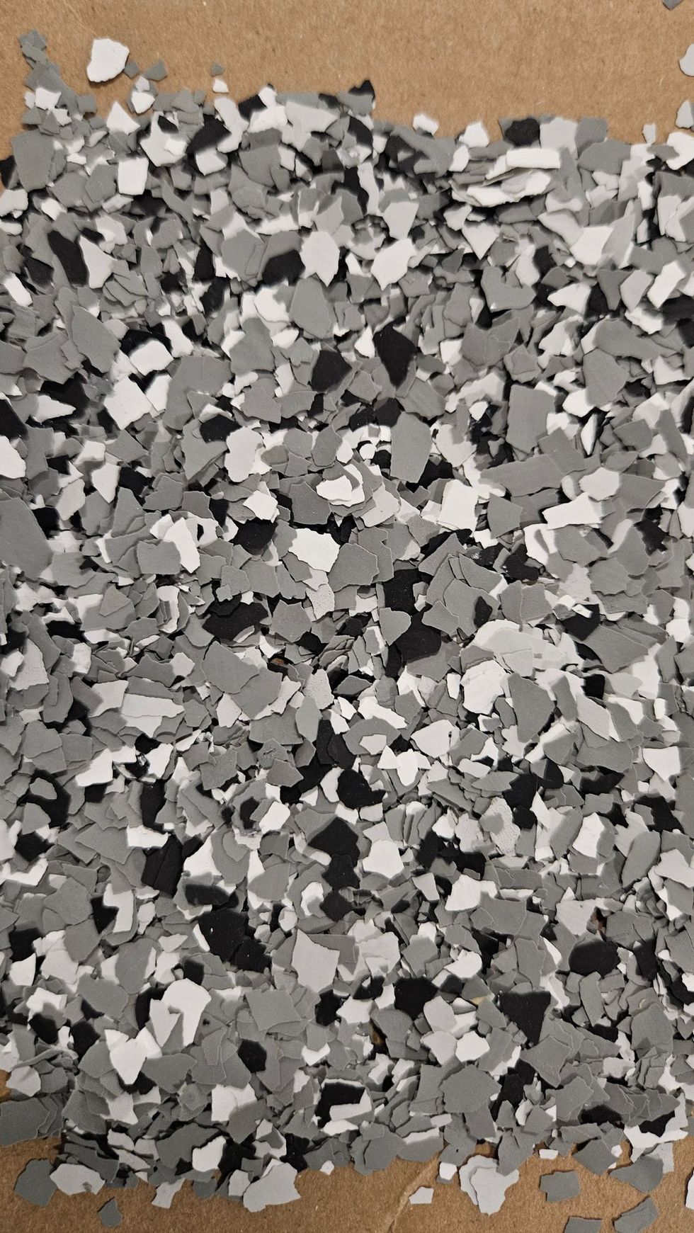 Gray, black, and white decorative floor chips.