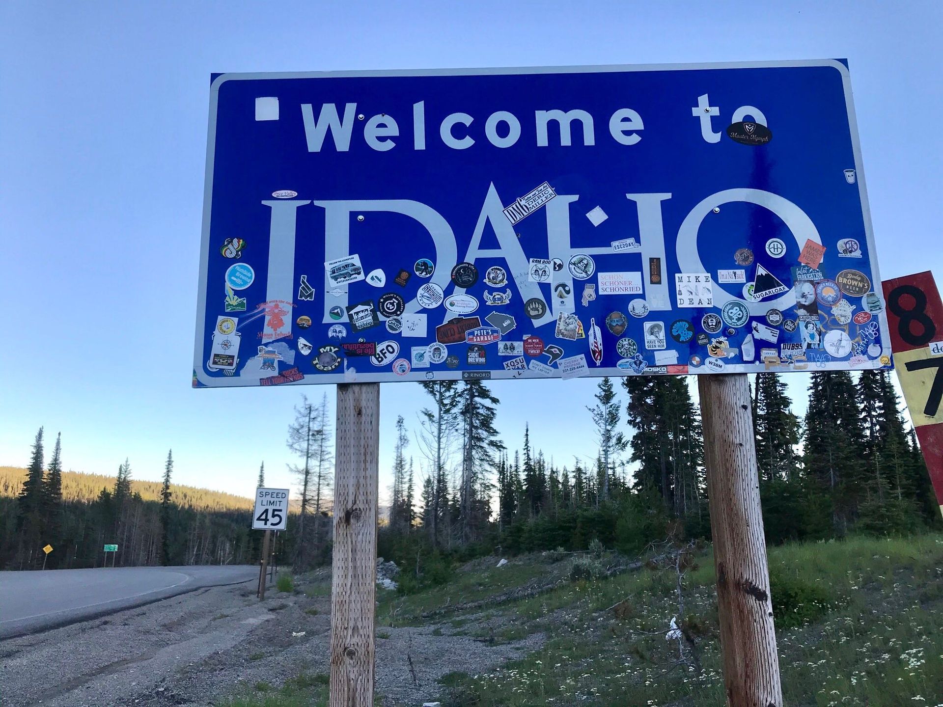 A blue and white sign that says welcome to idaho