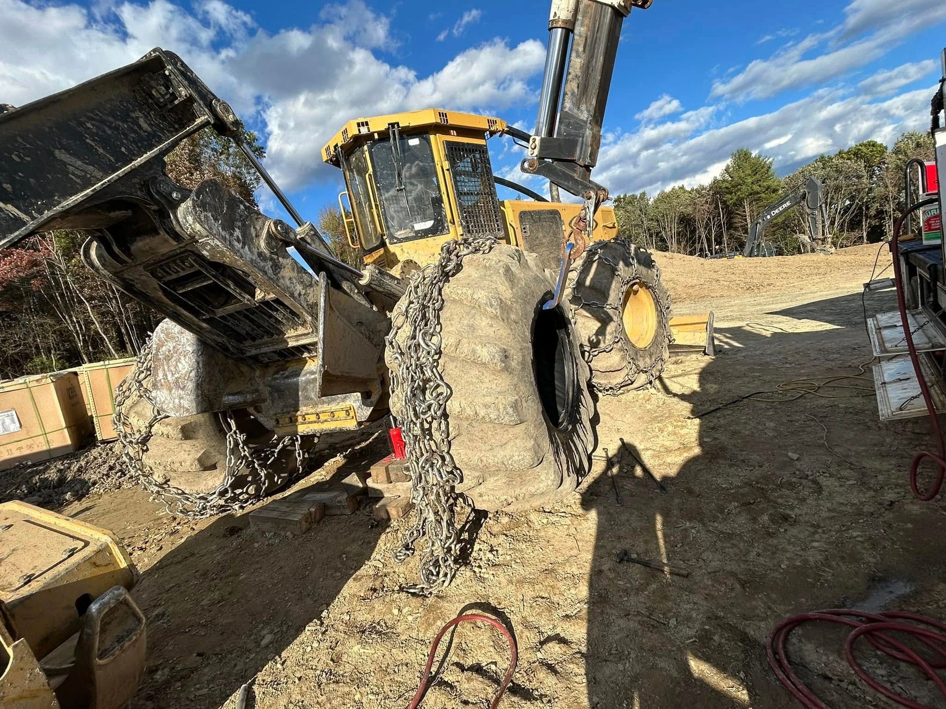 A bulldozer is sitting on top of a dirt field.