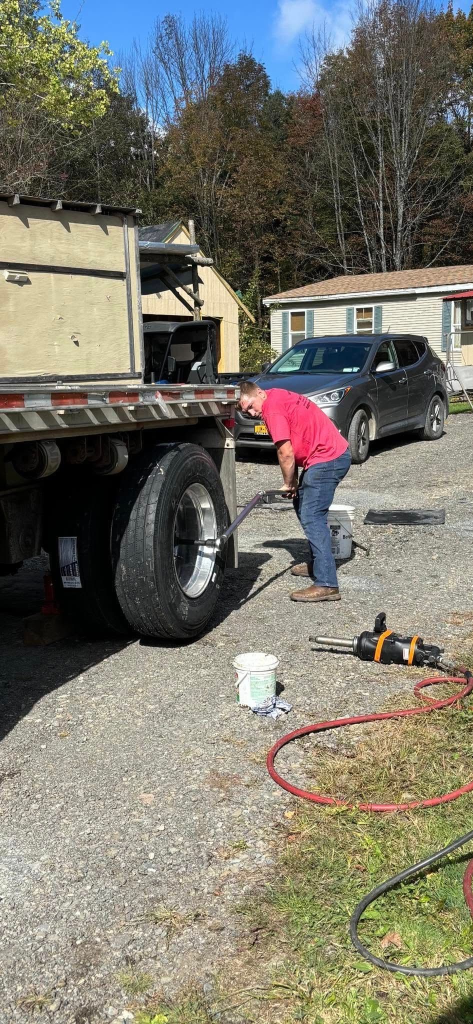 A man is working on the back of a semi truck.