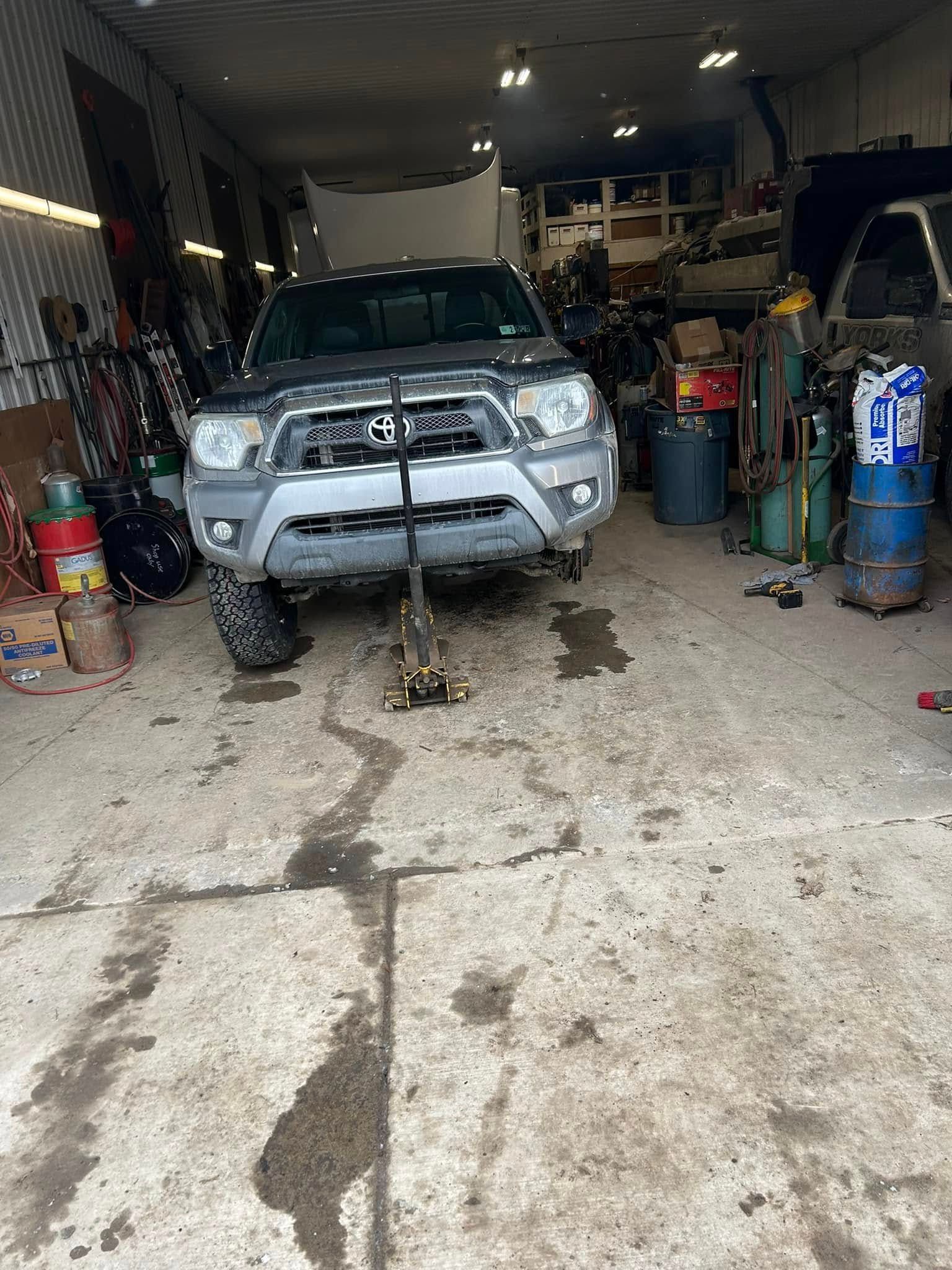 A toyota tacoma is being worked on in a garage.