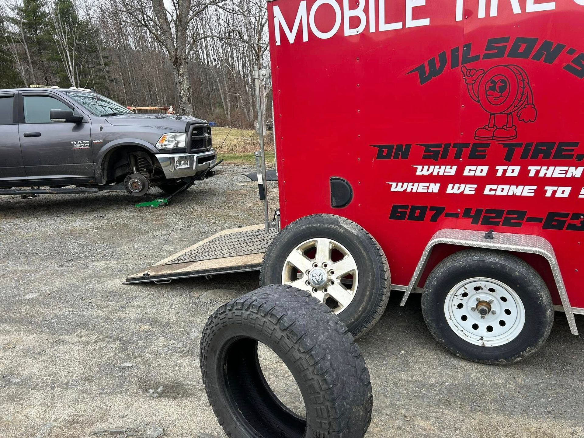 A red trailer with the word mobile tire on it