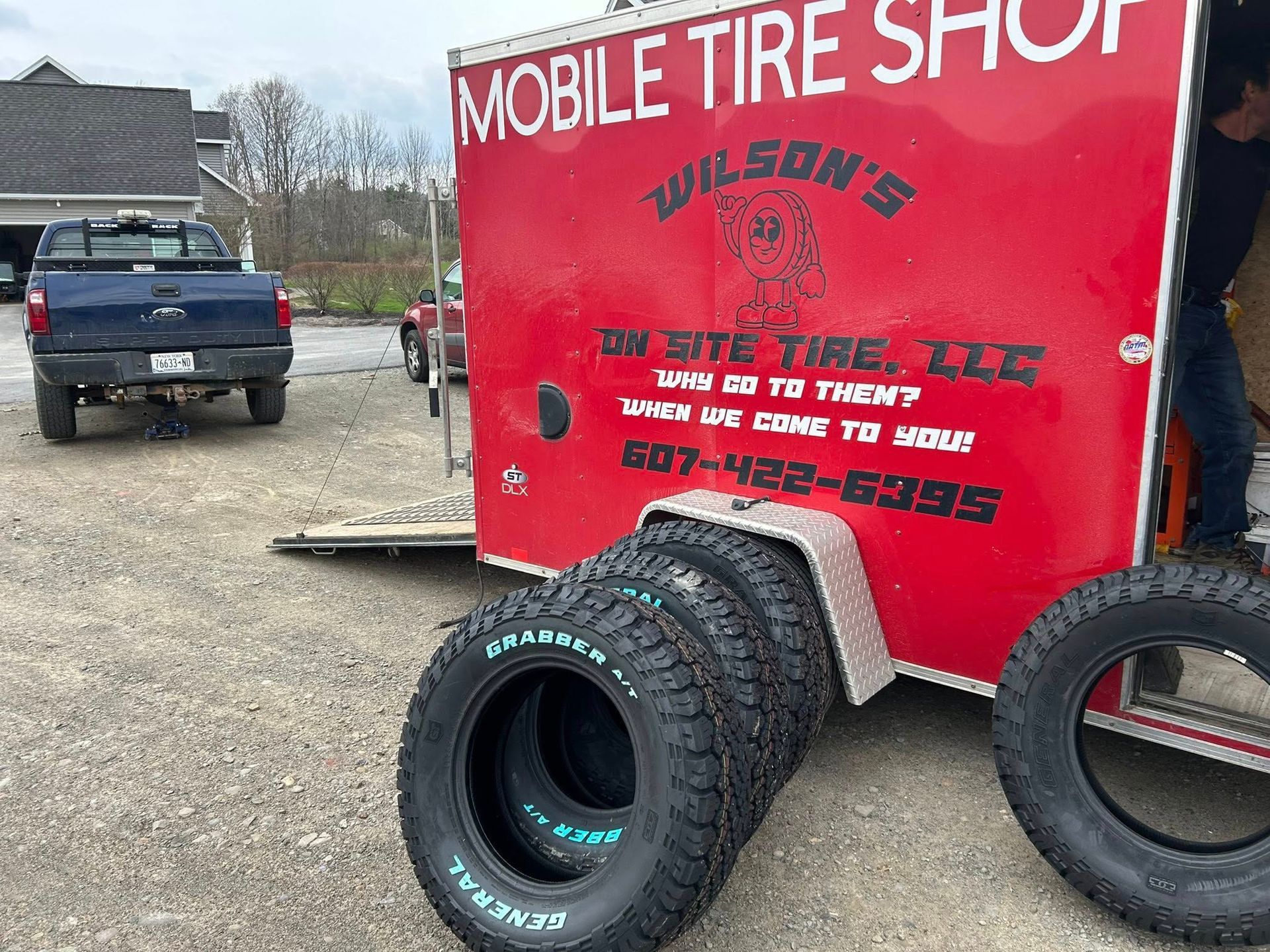 A mobile tire shop trailer with tires on it