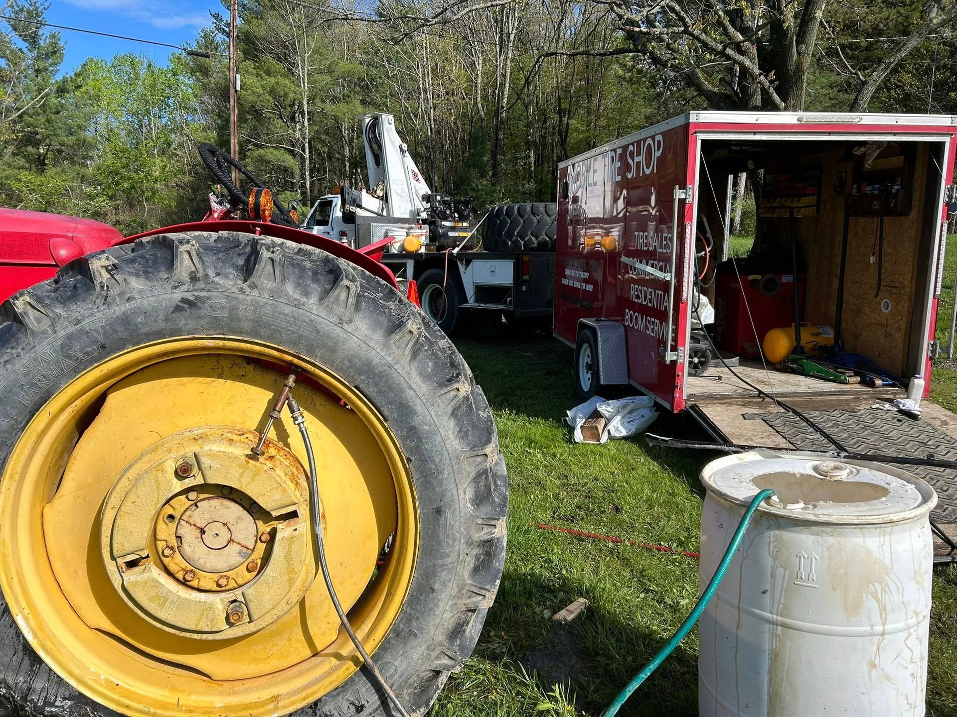 A tractor is parked next to a trailer with a hose attached to it.