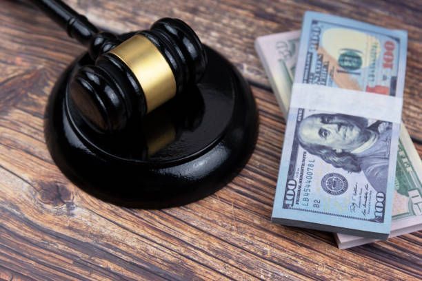 A close-up of a gavel and money, signifying bail bond services and legal financial transactions.
