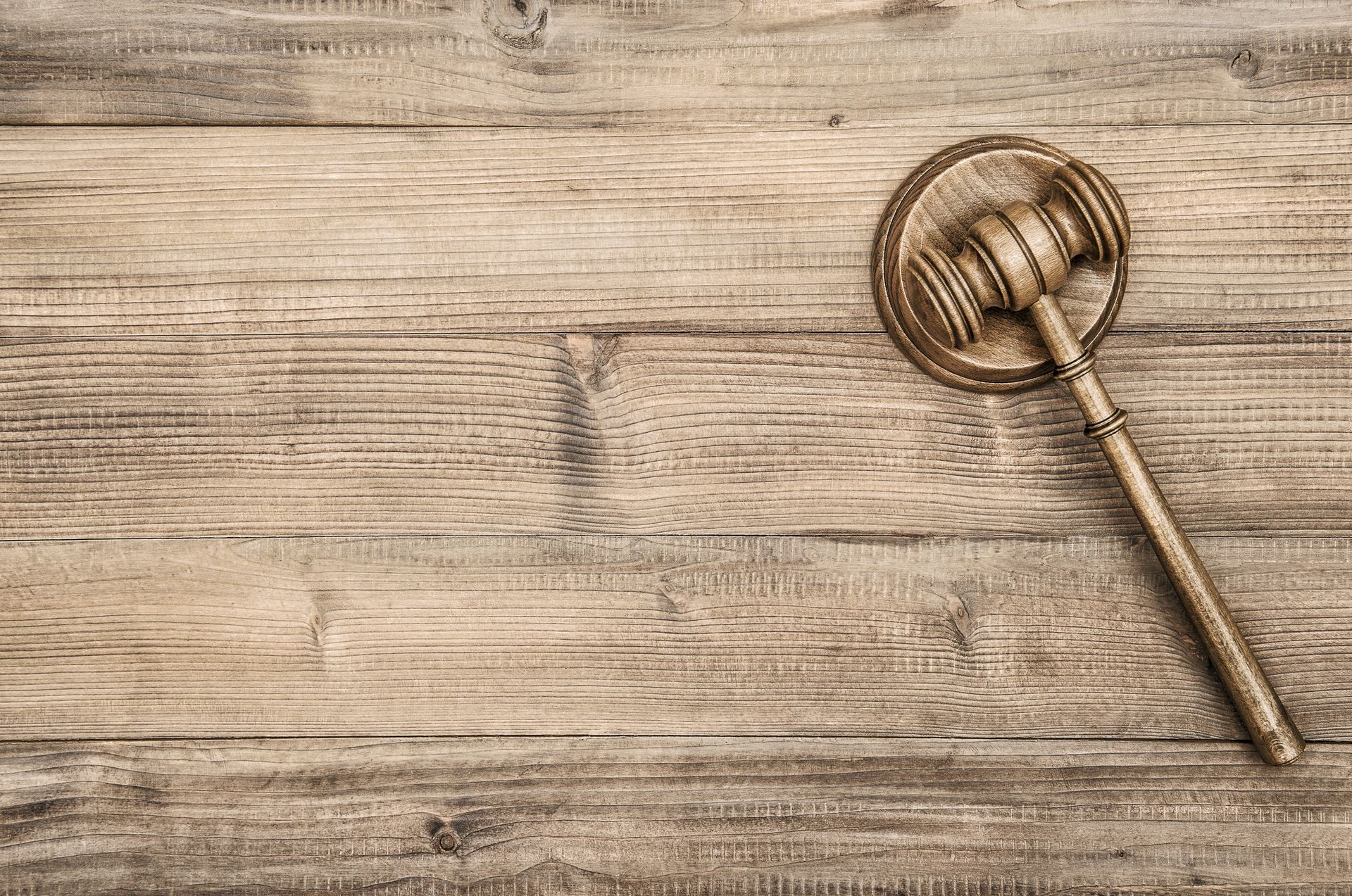 Gavel on a wooden surface.