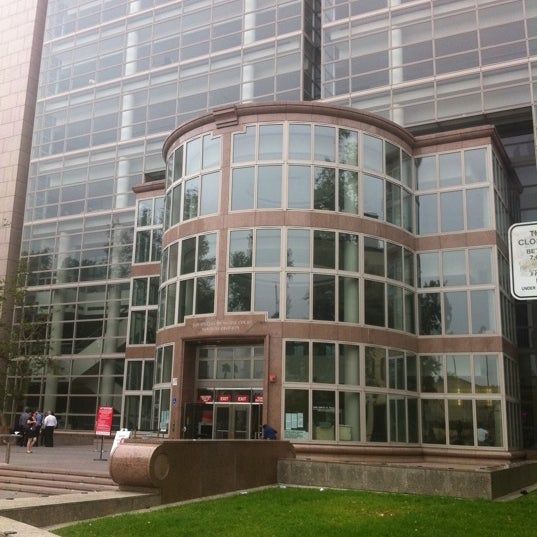 A black and white photo of the inside of a building with a dome roof.