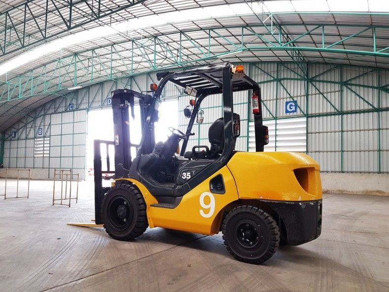 A Yellow Forklift is Parked in a Large Warehouse — Hire Power NT in Berrimah, NT
