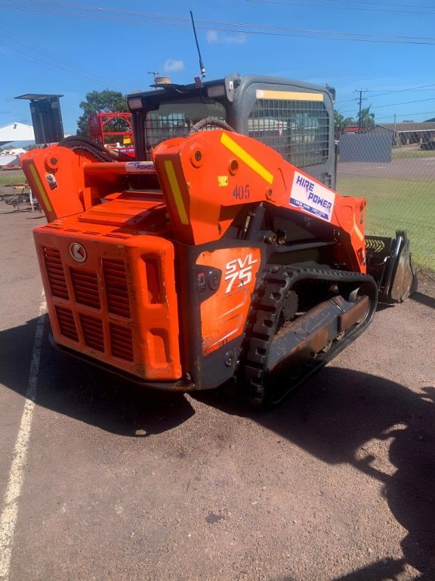 A Small Orange Tractor is Parked in a Parking Lot — Hire Power NT in Berrimah, NT