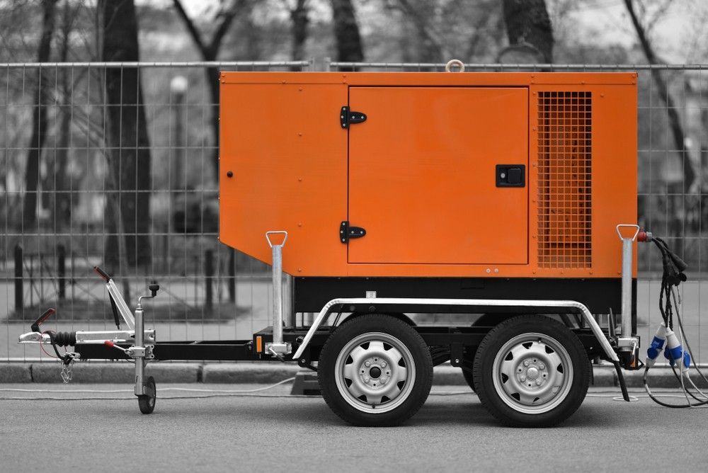 An Orange Generator on a Trailer is Parked on the Side of the Road — Hire Power NT in Berrimah, NT