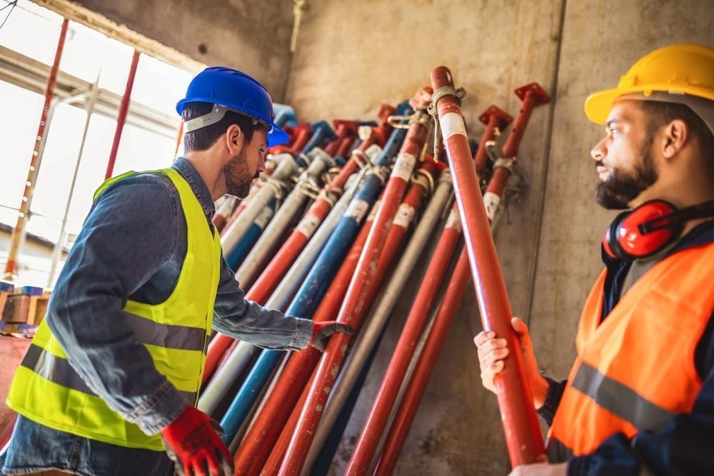 Two Construction Workers Are Working on a Construction Site — Hire Power NT in Berrimah, NT
