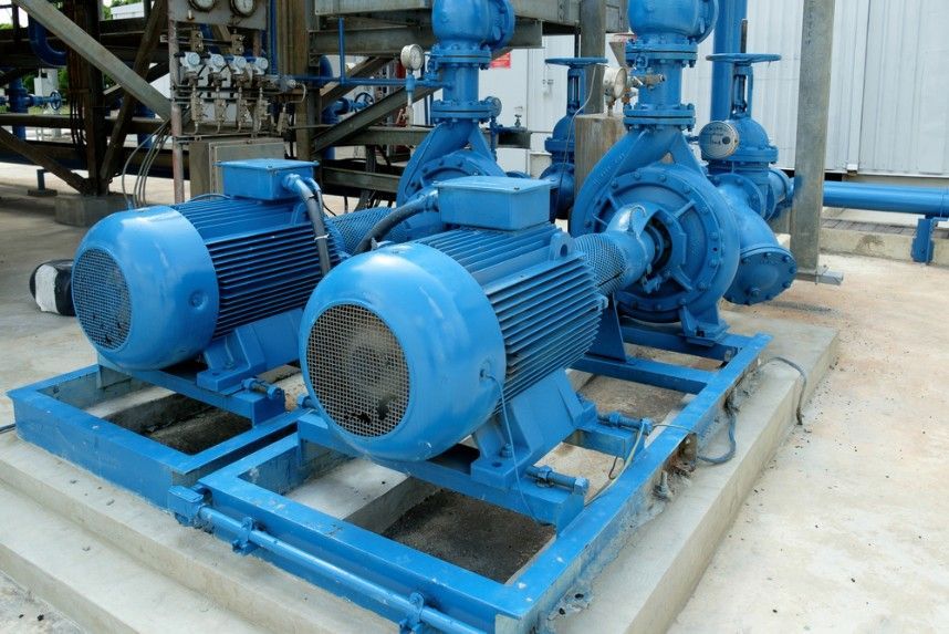 A Group of Blue Pumps Are Sitting on a Concrete Platform — Hire Power NT in Berrimah, NT