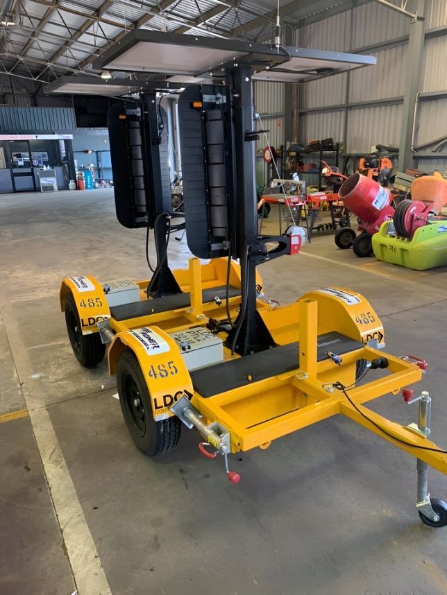 A Yellow Trailer With Two Lights on It is Parked in a Warehouse — Hire Power NT in Berrimah, NT