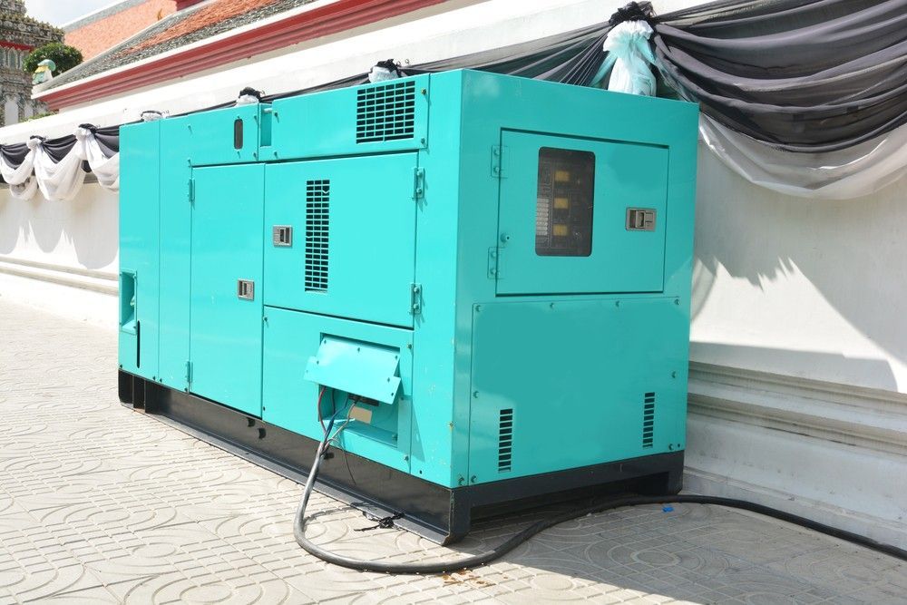 A Blue Generator is Sitting Next to a White Wall — Hire Power NT in Berrimah, NT