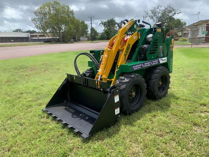 A Green and Yellow Tractor is Parked in a Grassy Field — Hire Power NT in Berrimah, NT
